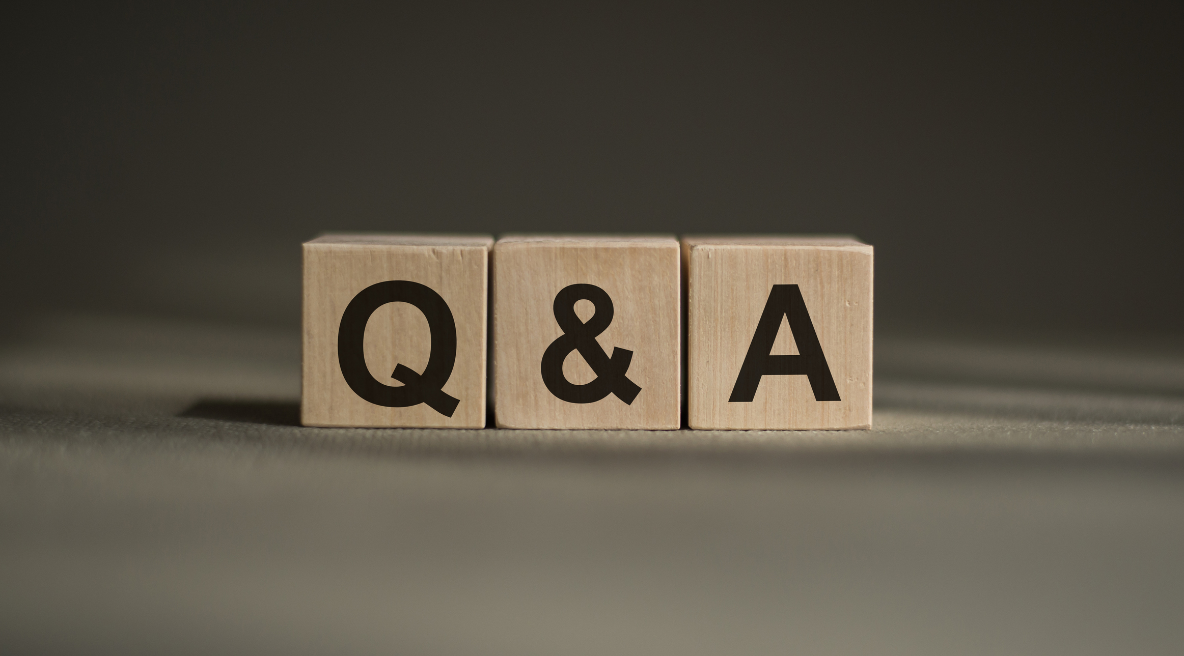 Question and answer form on a wooden block on a gray background, LED Retrofit.