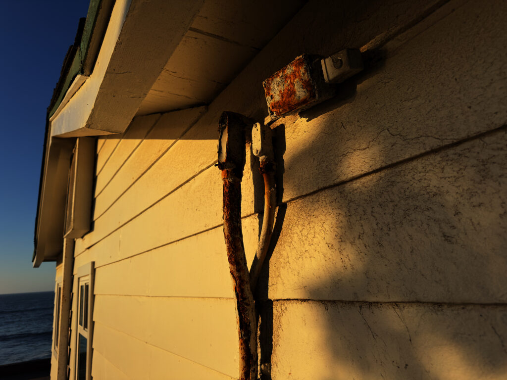 Rusted outdoor electrical outlet, service mast repair.